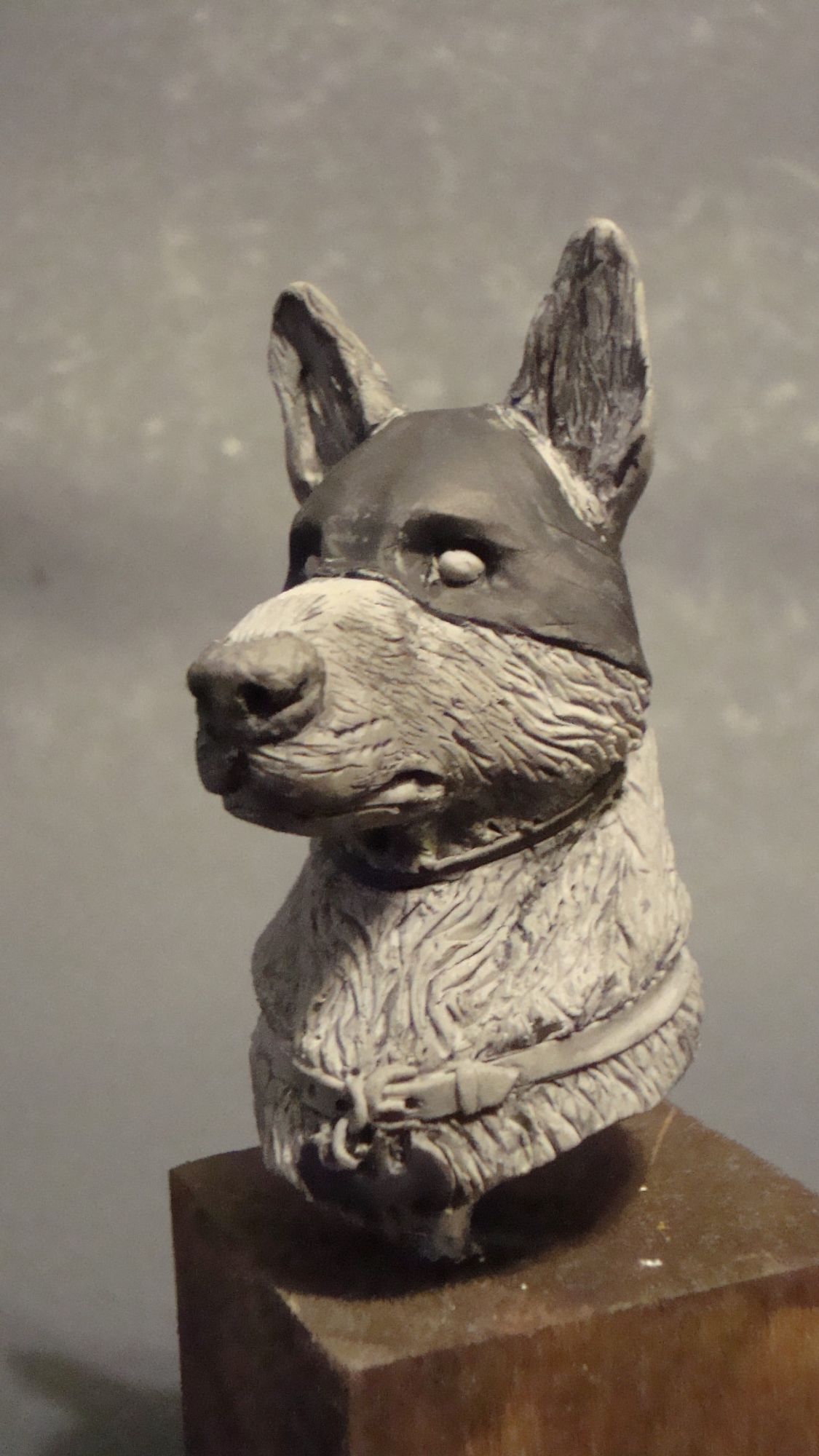 Minibust of Ace the Bathound, a German Shepherd in a mask, left 3/4 view, mounted on a wooden cube