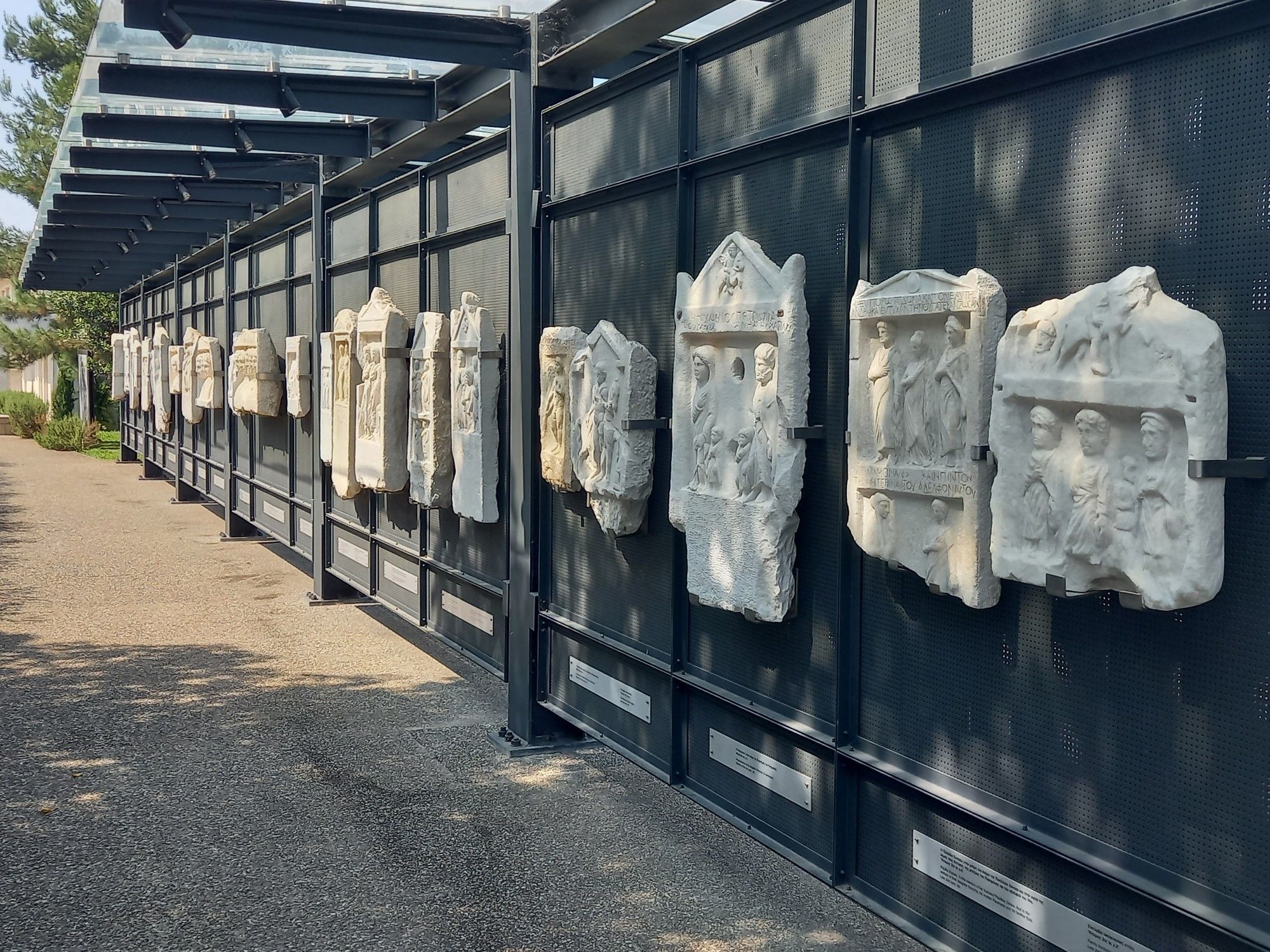 Memorial wall of ancient gravestones, outside the Archaeological Museum of Veroia.