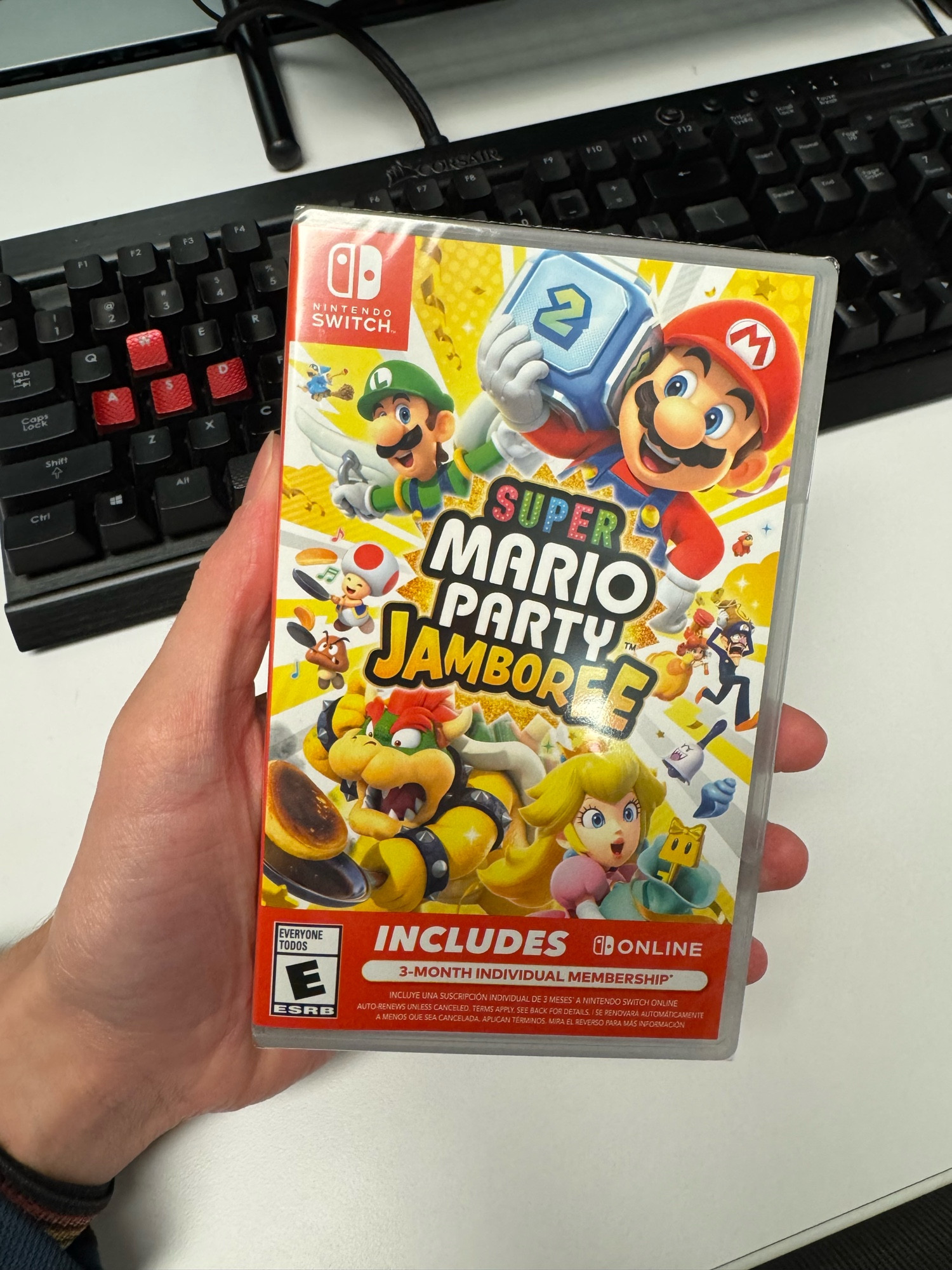 Holding a copy of Super Mario Party Jamboree