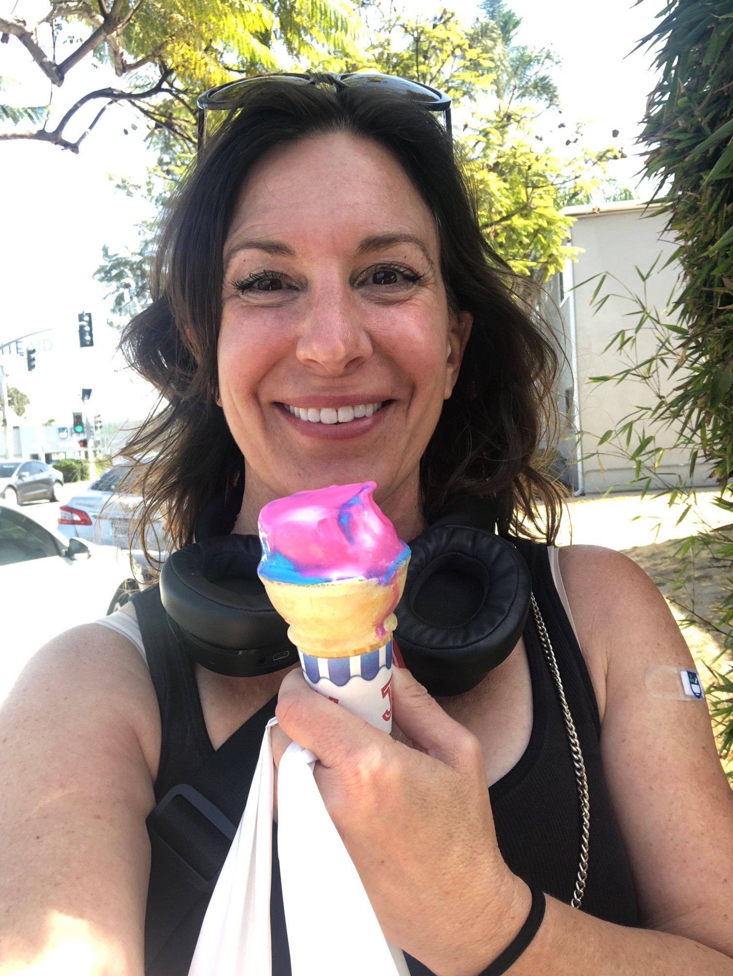 Me proudly holding up a coke filled with brightly colored ice cream. I'm also hoping a shopping bag and have a bandage on my arm. I look absolutely giddy.