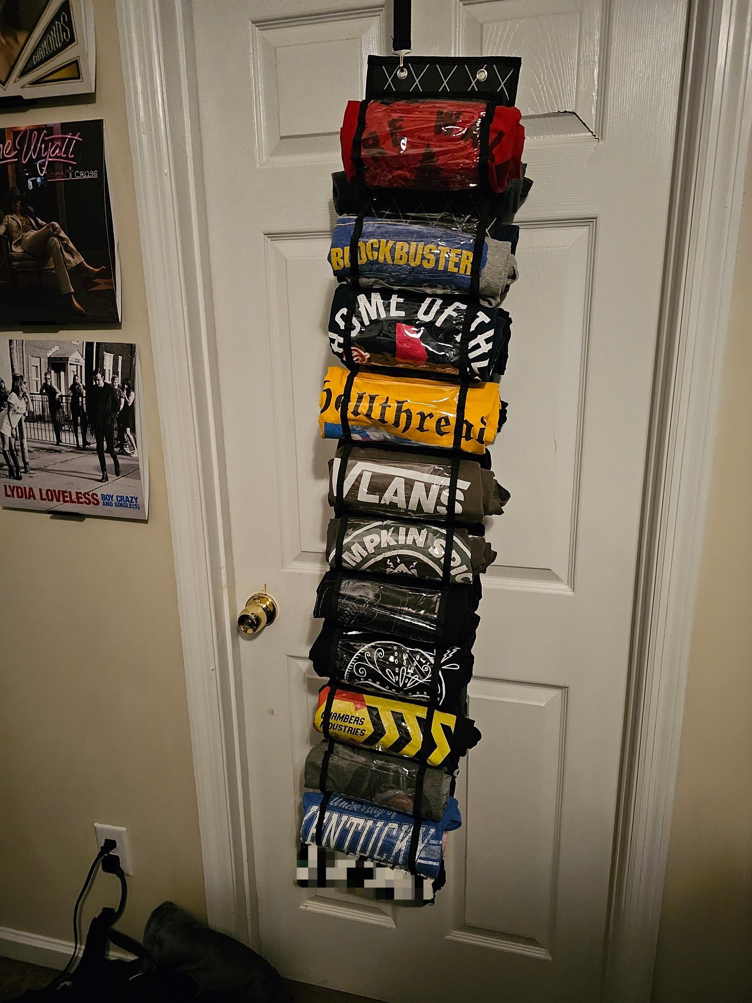 a hanger with 12 visible shirts, and 12 on the back, hanging in a door frame