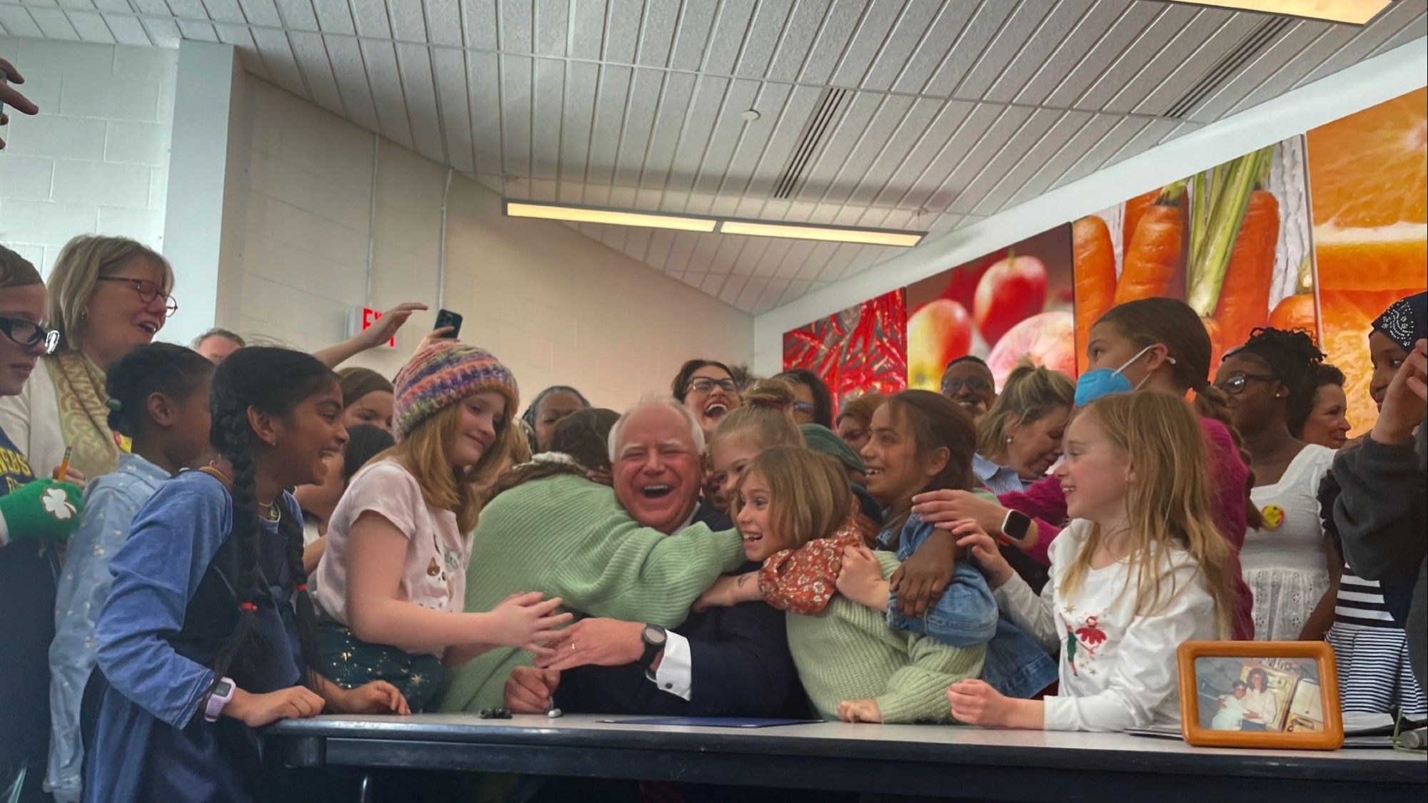 walz surrounding by thrilled kids. theyre all hugging him. This is the happiest a man has ever looked. No, seriously.