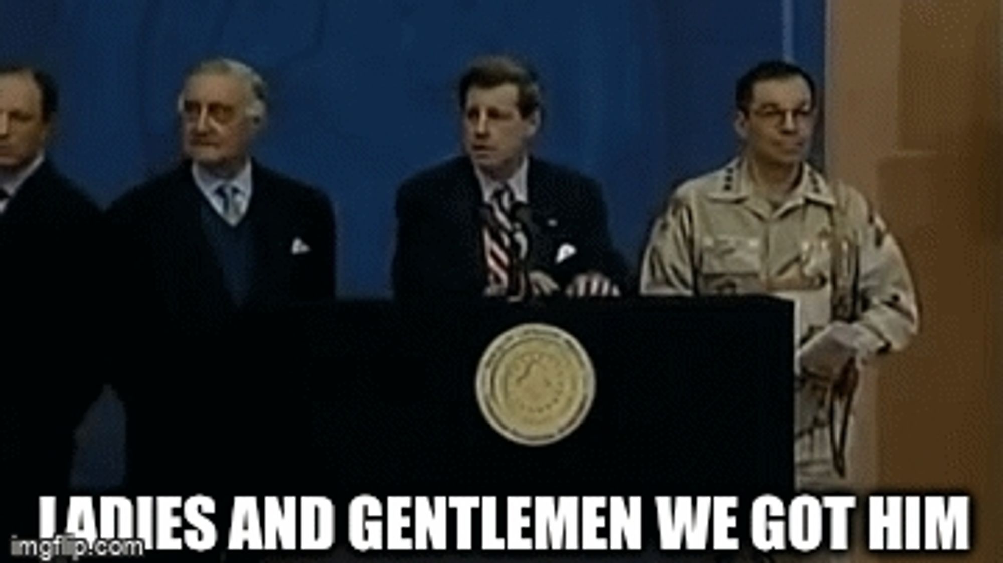 Shithead Paul Bremer announcing "ladies and gentlemen we got him" after the capture of Saddam Hussein