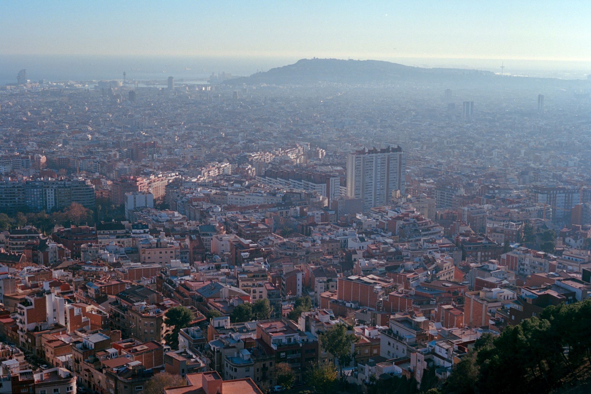 View over a hazy Barcelona in December 2023 on analog film.