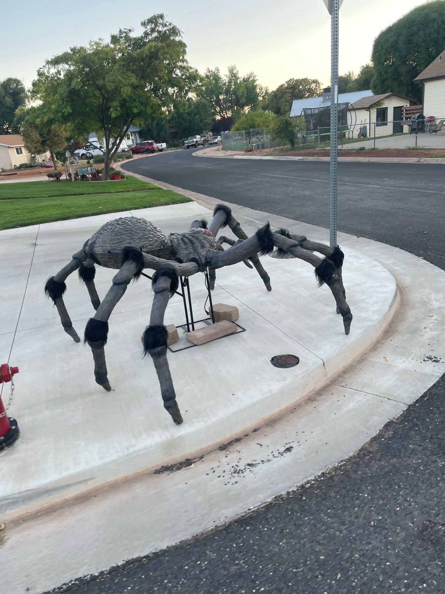 a giant spider the size of a small car on a street corner