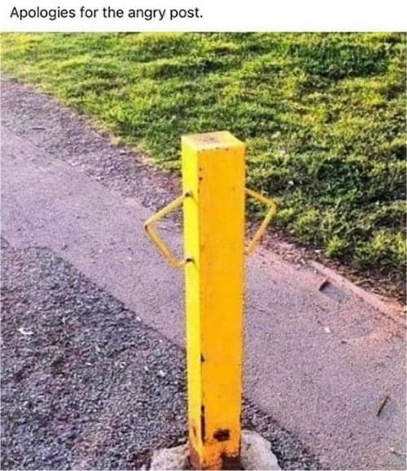 Picture of yellow metal post with handles that look like a human posturing