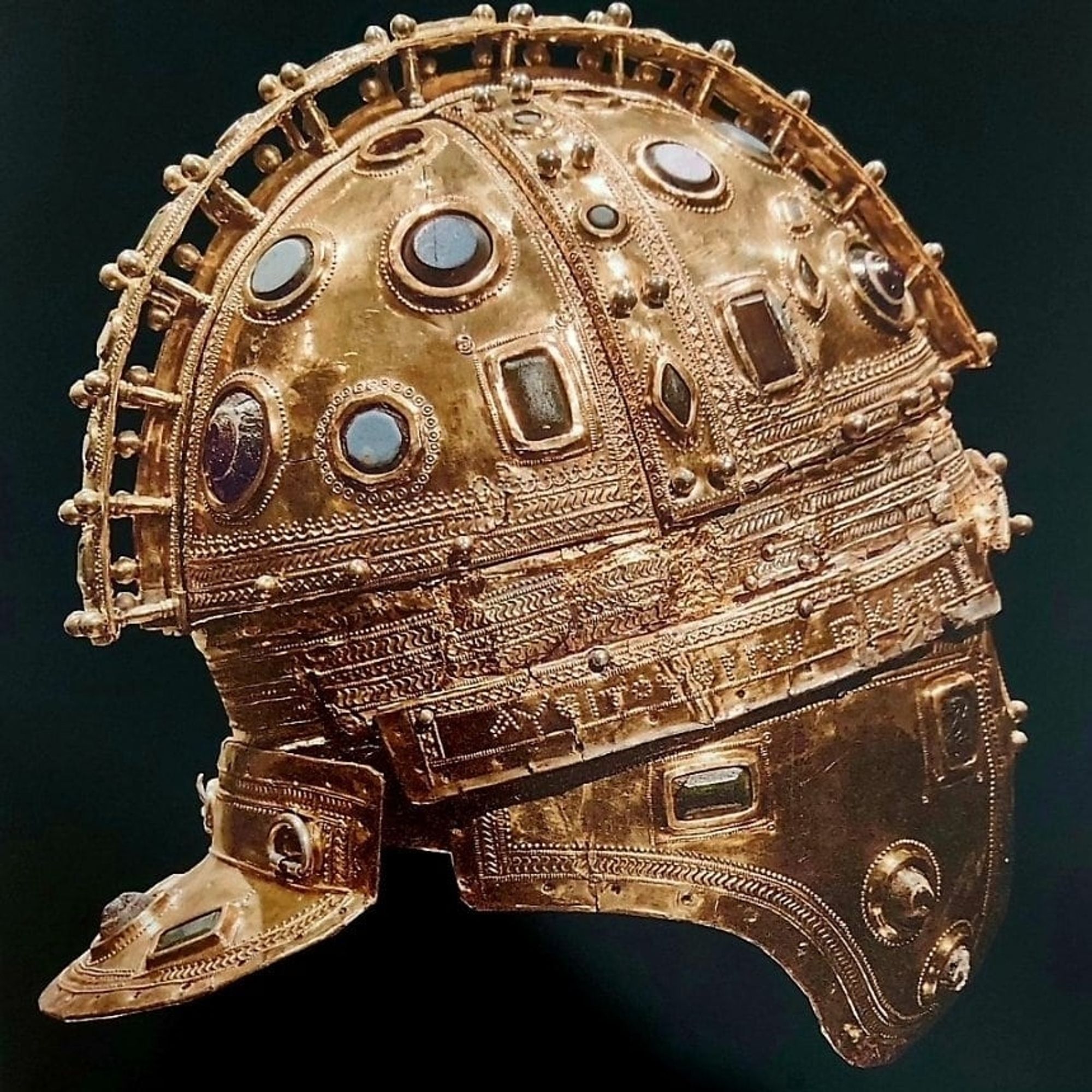 A 4th century CE Roman parade helmet made of iron, silver and gold, and decorated with glass gems.