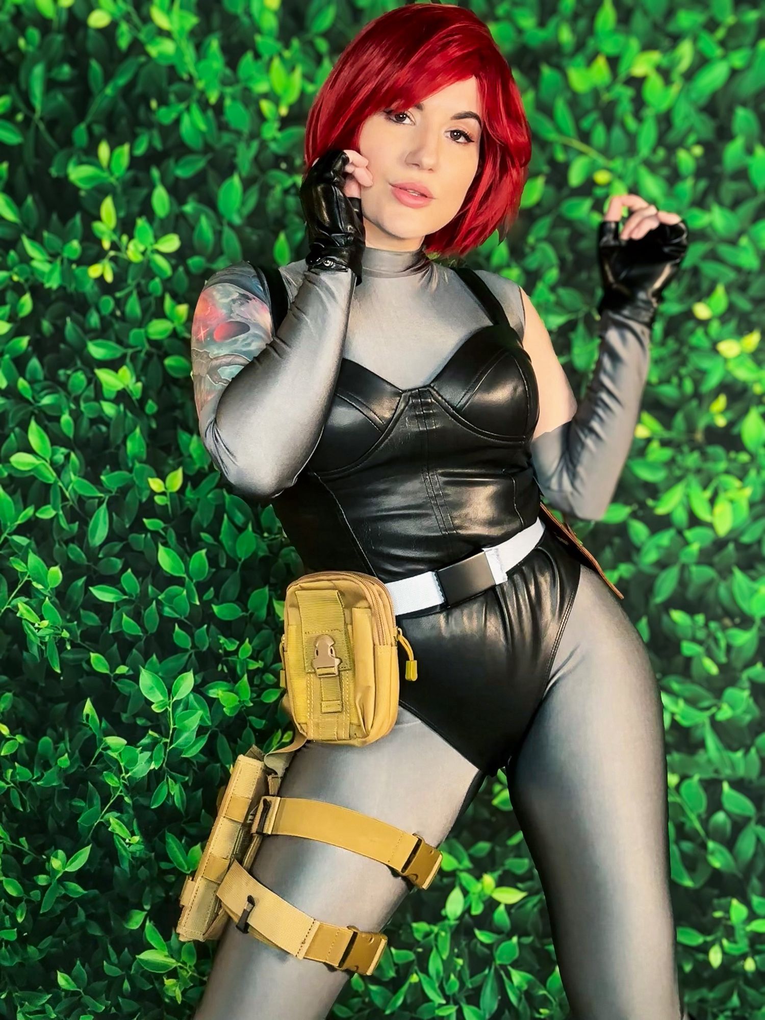 photo of bloodyfaster in cosplay as regina from  the game dino crisis in front of a green leafy background