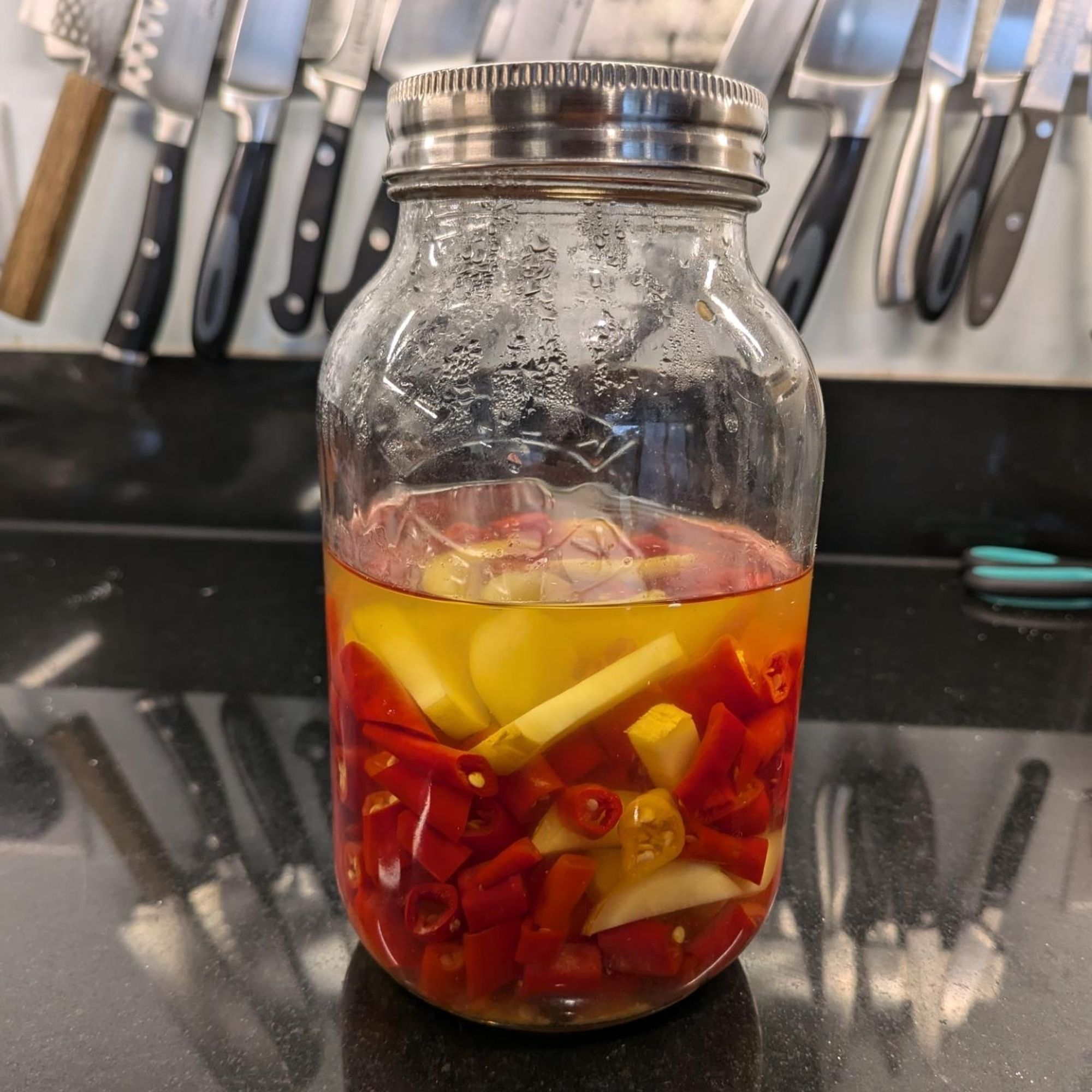 Chili, garlic and ginger in a lacto fermentation vessel.