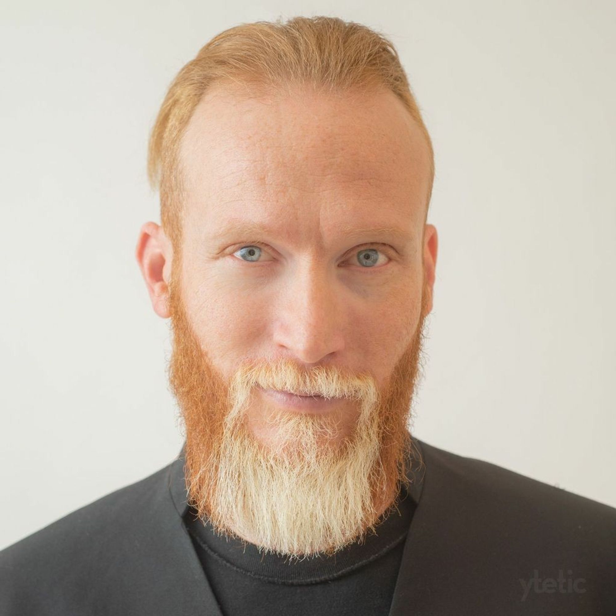 2. Headshot with black shirt & jacket.