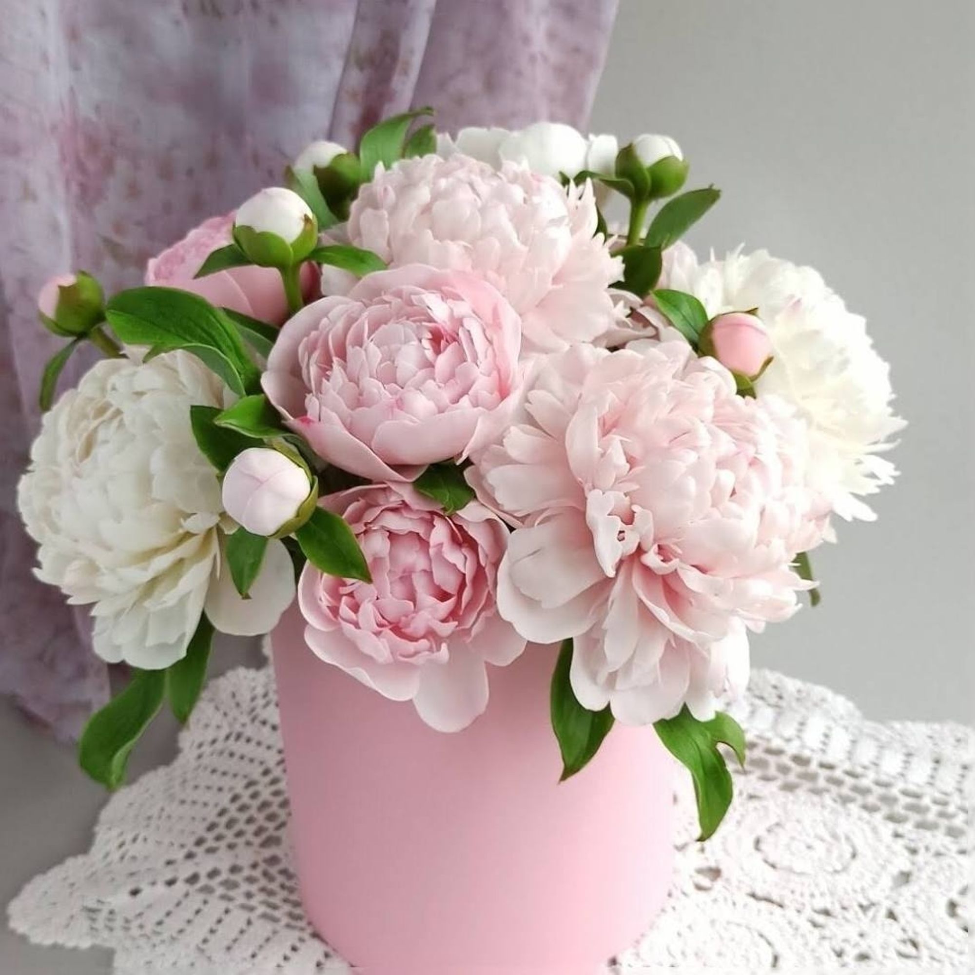 Pink peony bouquet in a pink bucket vase