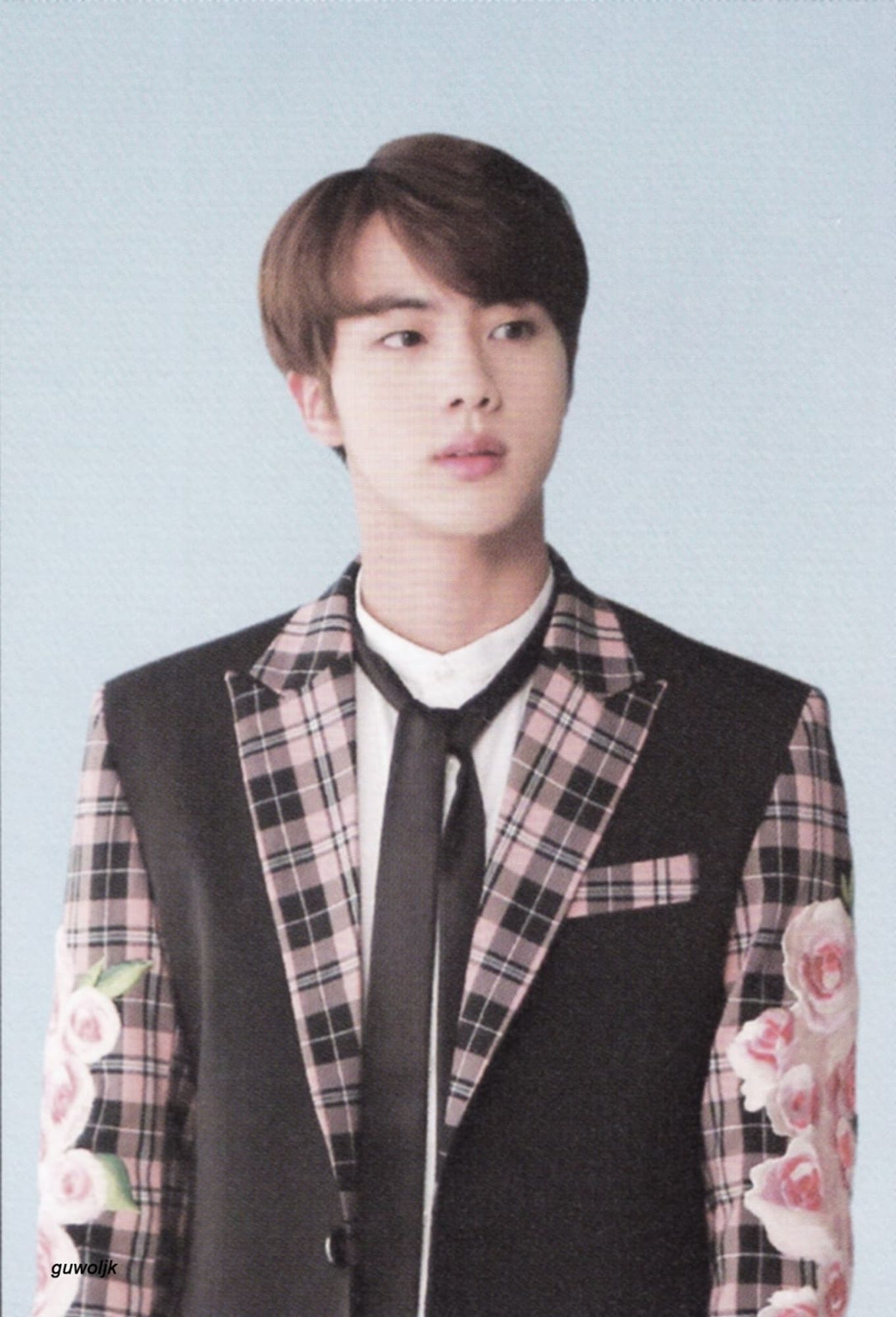 Seokjin wearing a pink and black plaid suit