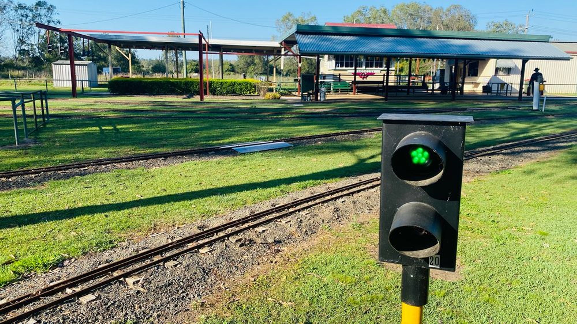 A model railway signal showing a green light