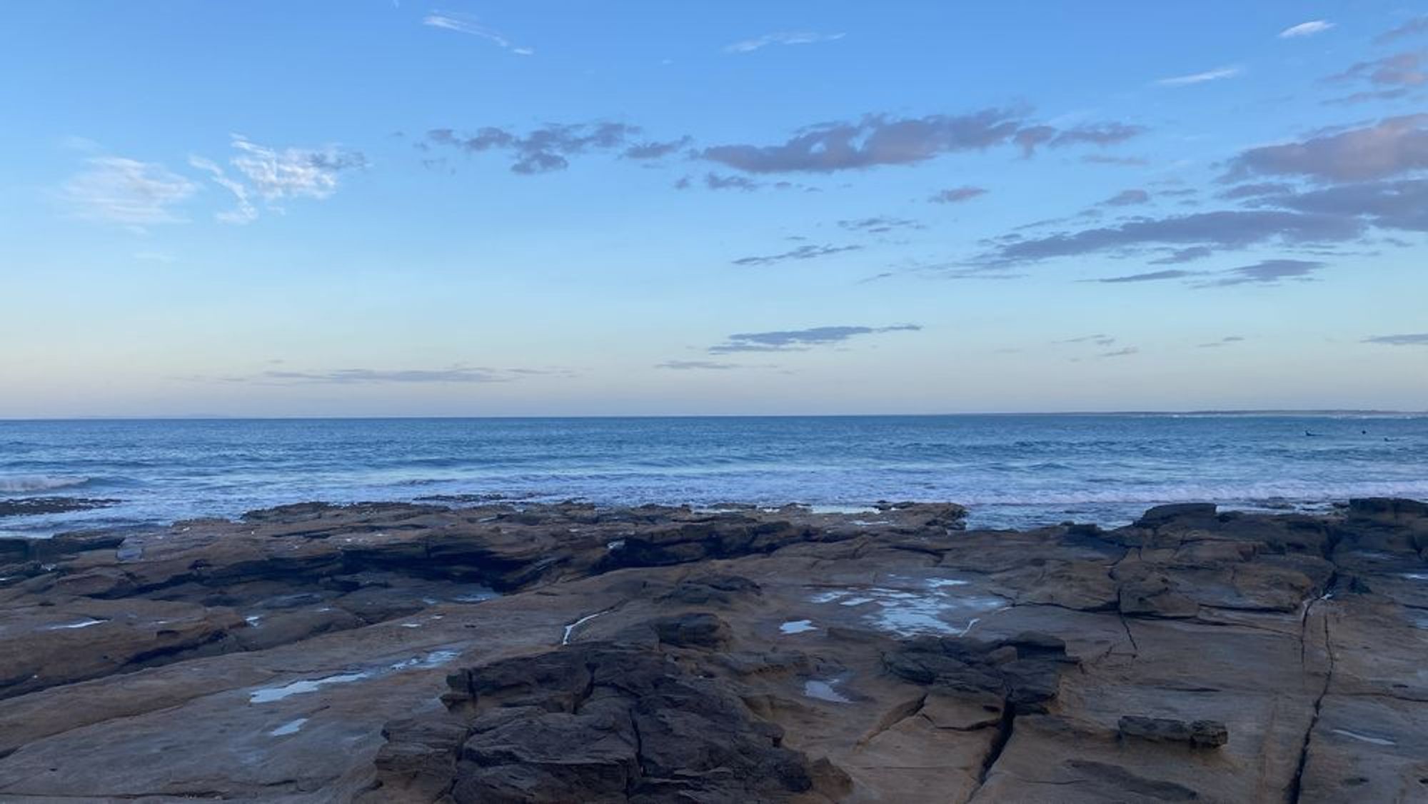 A view of the ocean with a rocky shore 