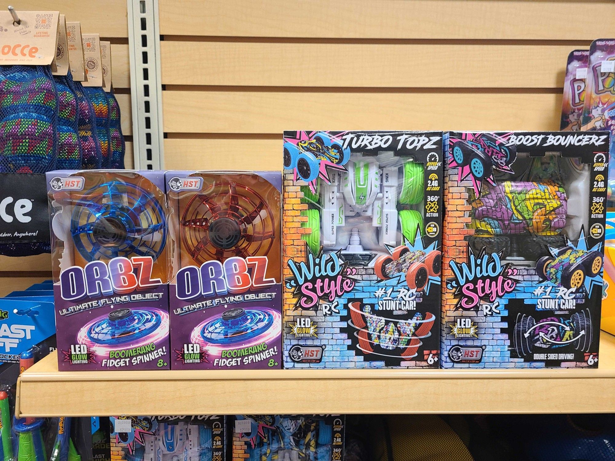 Orbz Boomerang Drone and Wild Style RC Car on the shelf at the Games by James/Air Traffic Toys Combo Store at Ridgedale Center.