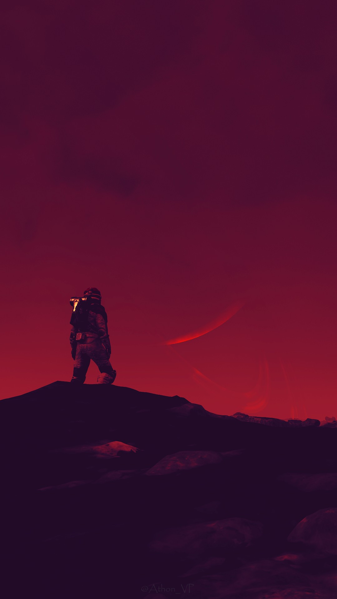 My Starfield character standing on a rocky hill, staring out at a red sky, with a planet and its ring faintly and partially visible in the distance.