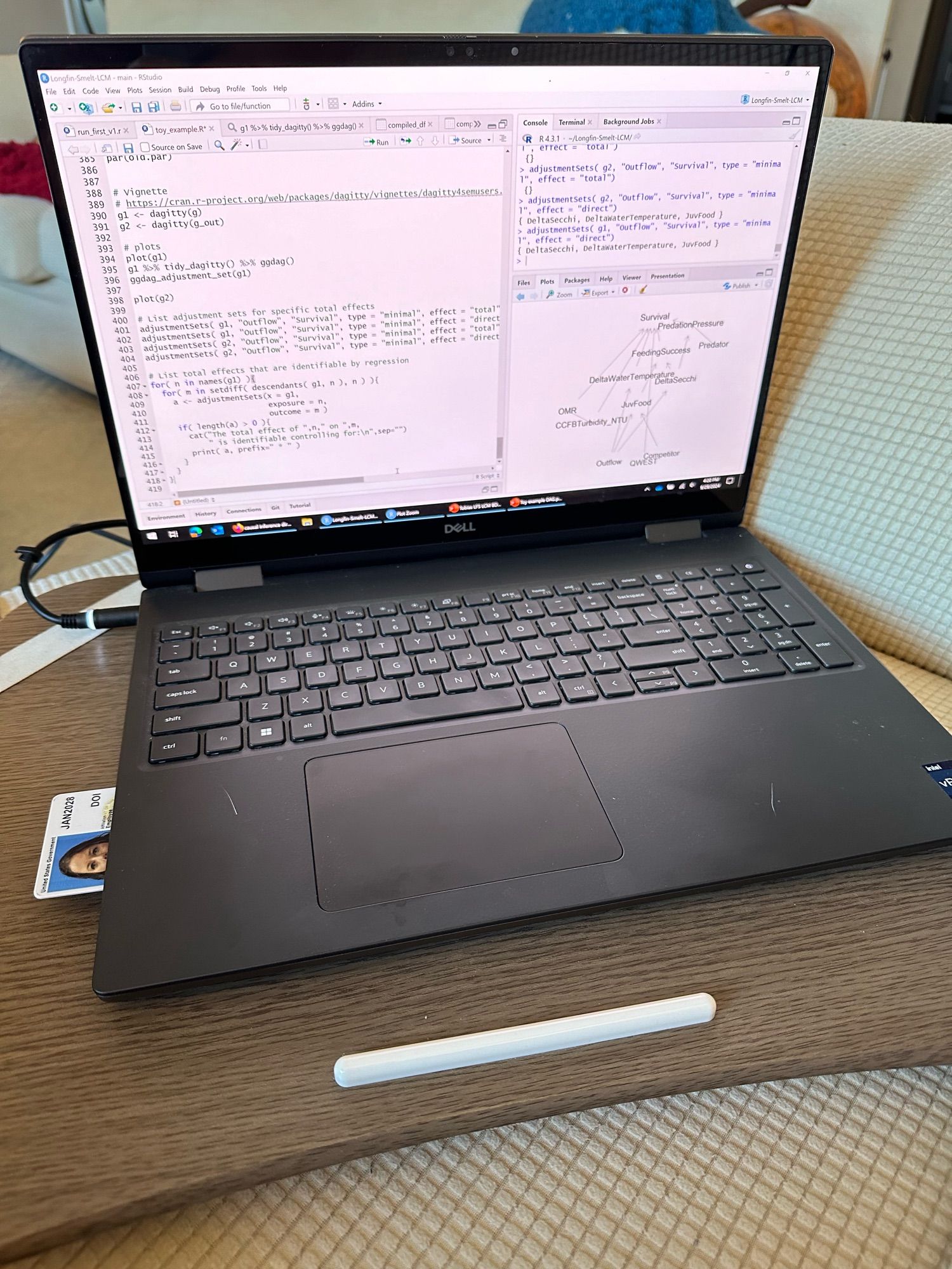 A laptop with an RStudio window open on the screen.