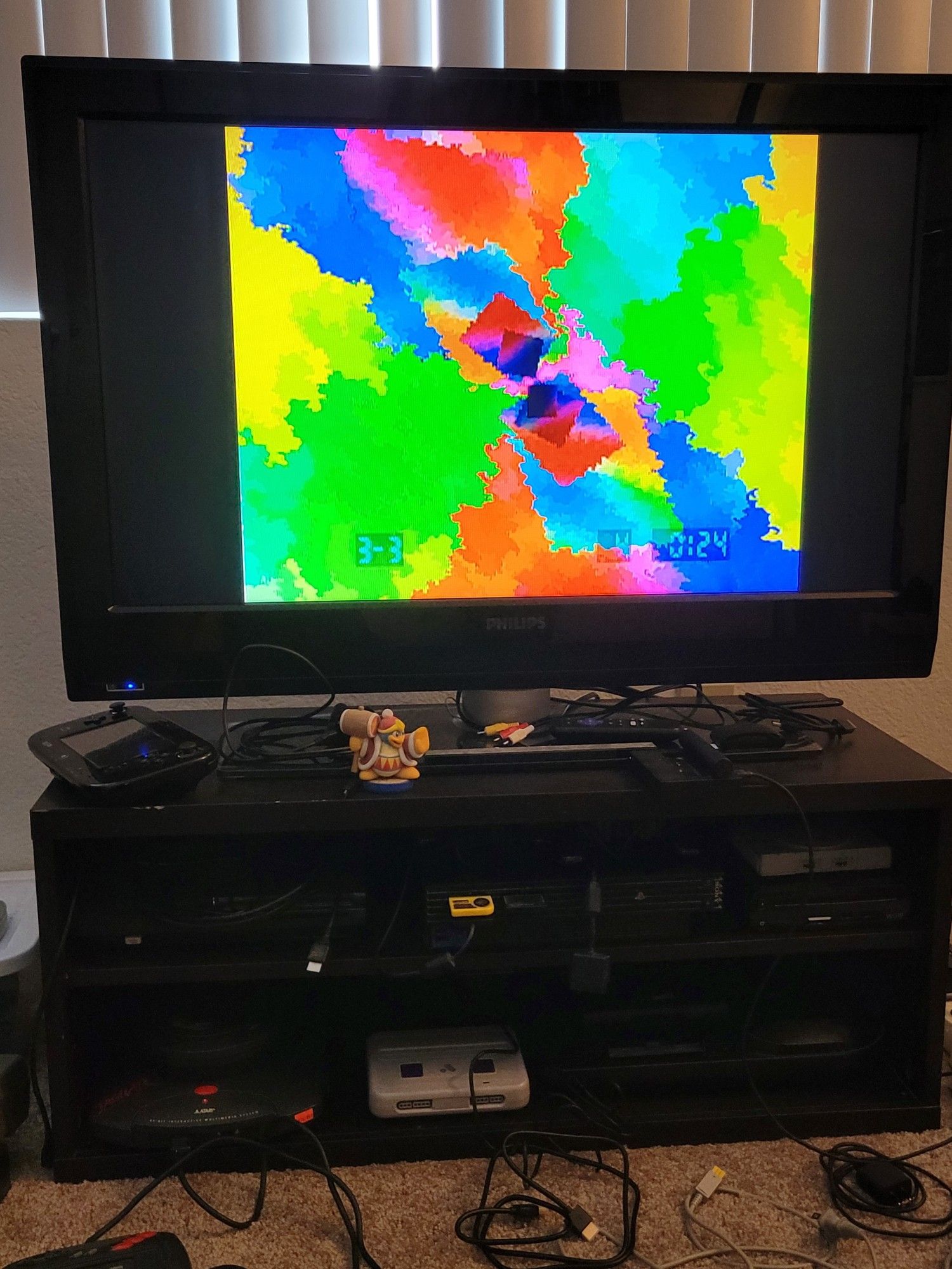 Console setuo with a Jaguar CD, with the television putting on a light show playing some Overclocked ReMix FF6 music on there.