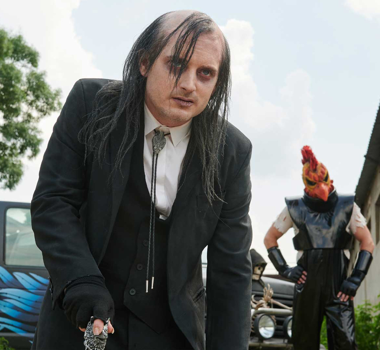 Elijah Wood is playing the role of Fritz Garbinger. He looks exactly the way I drew him. Theres a chickenheaded man in the background