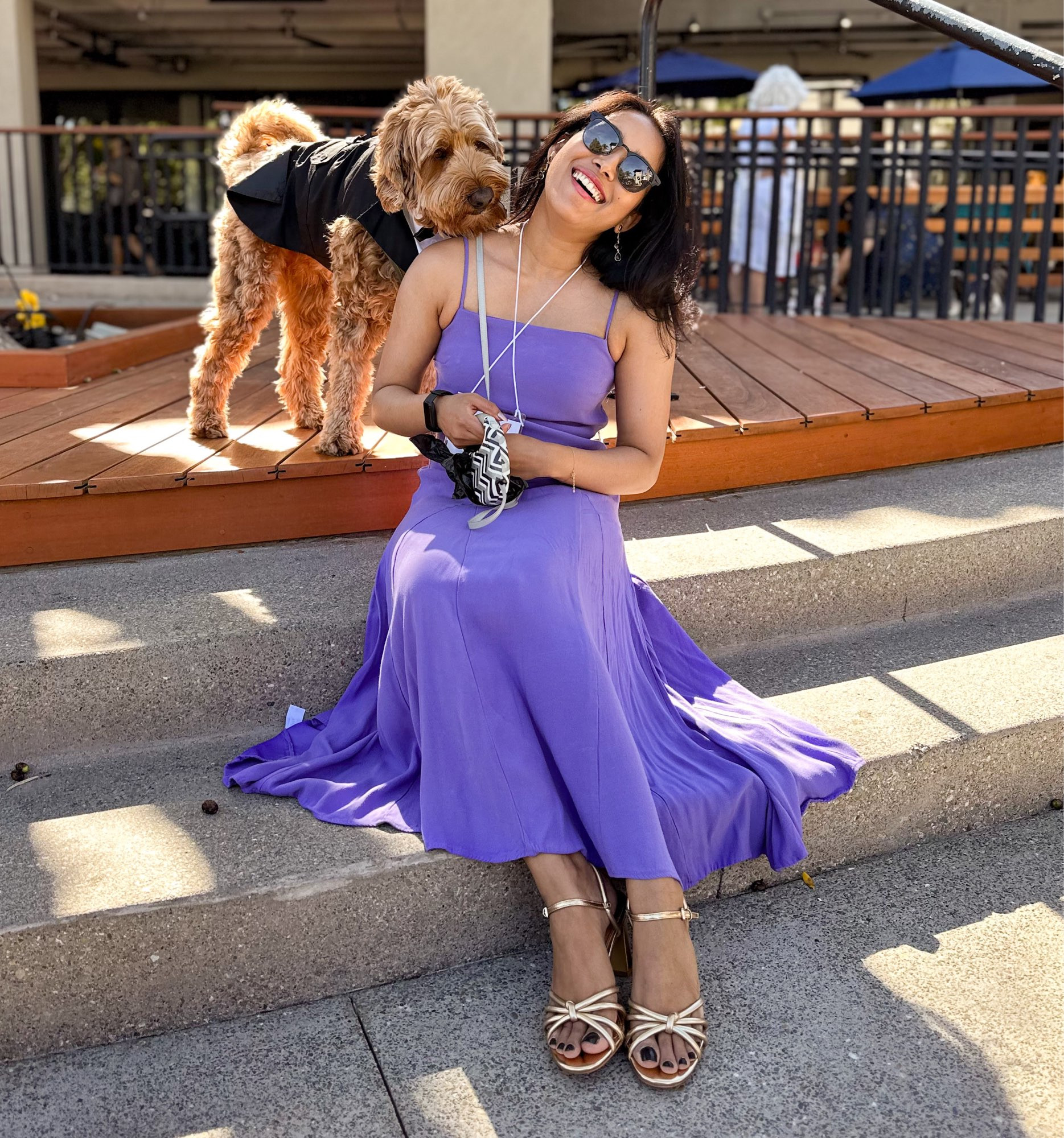 Bindiya wearing a long purple dress and Apollo in a tuxedo, both have big smiles on