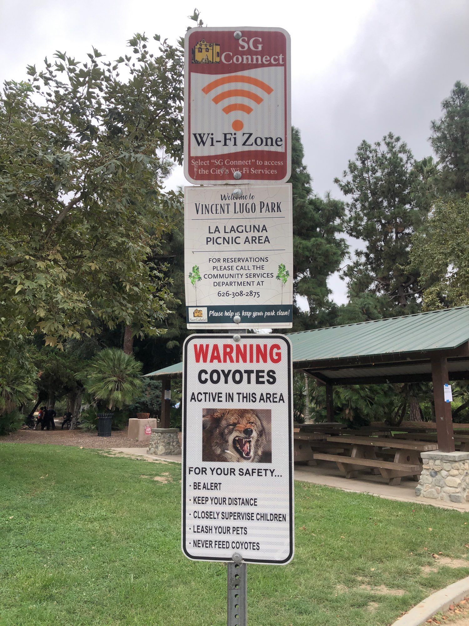 Signs about how there are both Wi fi and coyotes at the park