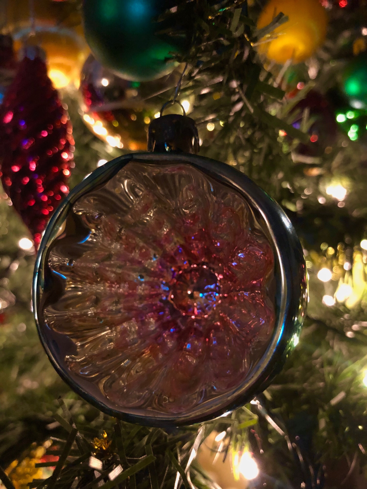 A vintage glass indented Christmas tree bauble on the tree.