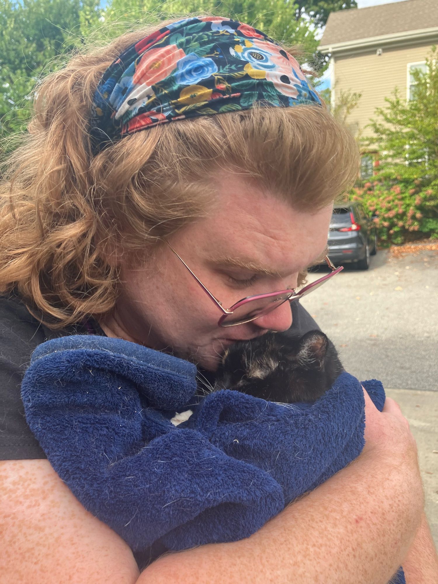 A sad lady holding a good cat