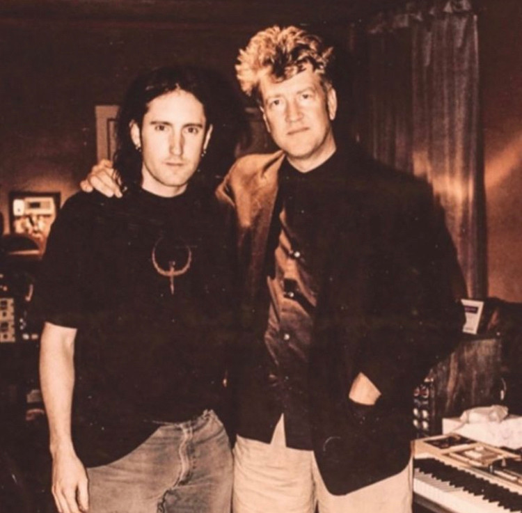 A photo of Trent Reznor and David Lynch circa 1996. Trent is wearing a Quake shirt.