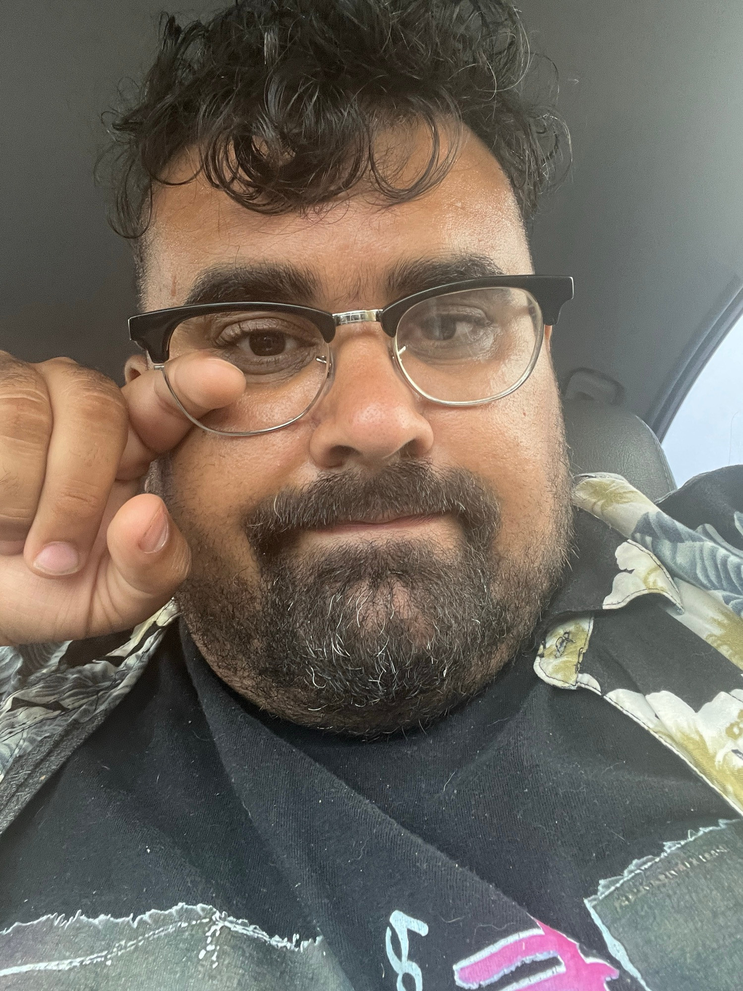 Me forlornly wearing my broken glasses popping a finger through the empty broken frame 