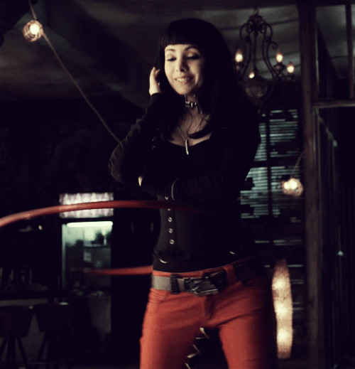 Kenzi from Lost Girl hula hooping while on the phone.