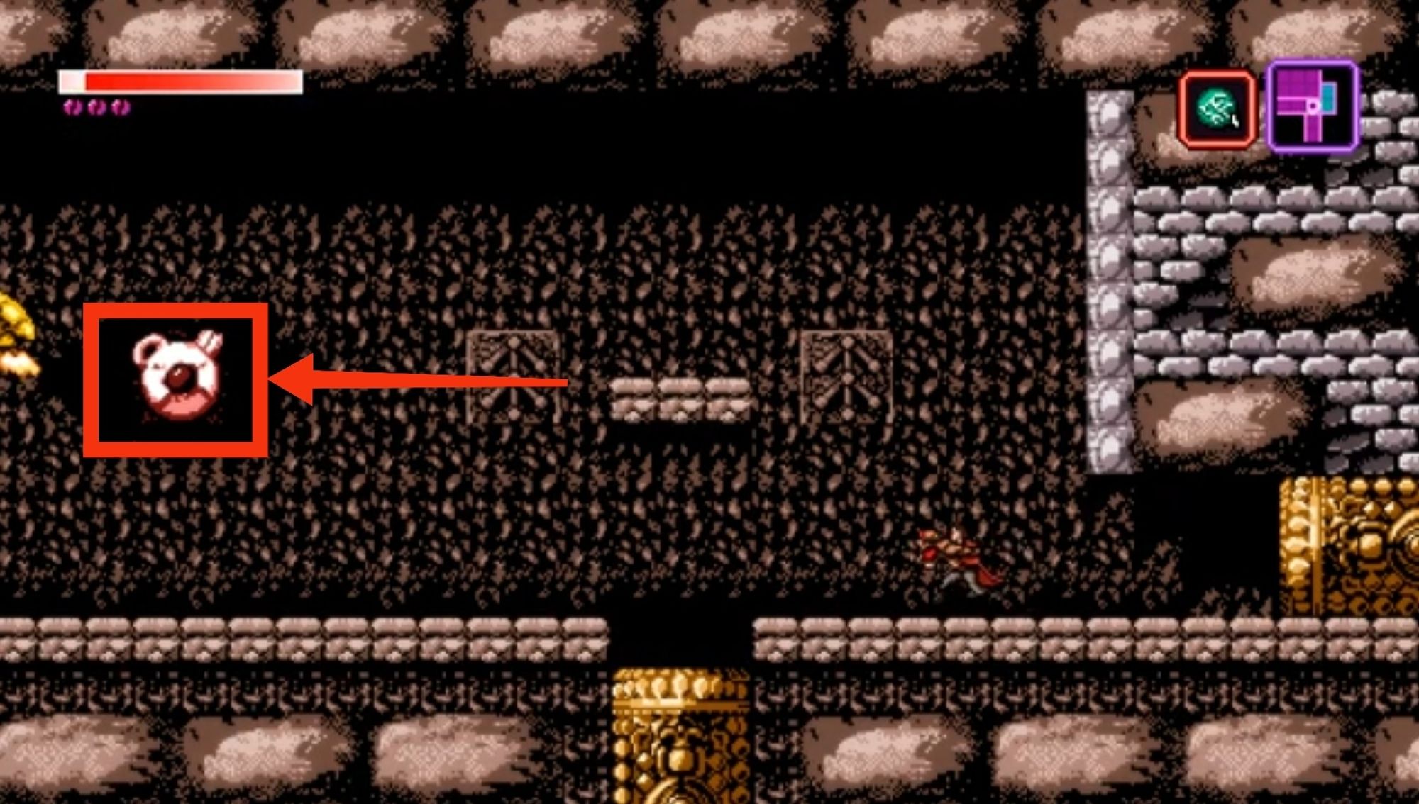 Screenshots du jeu Axiom Verge où un motif mural me fait penser à un nounours pas content.