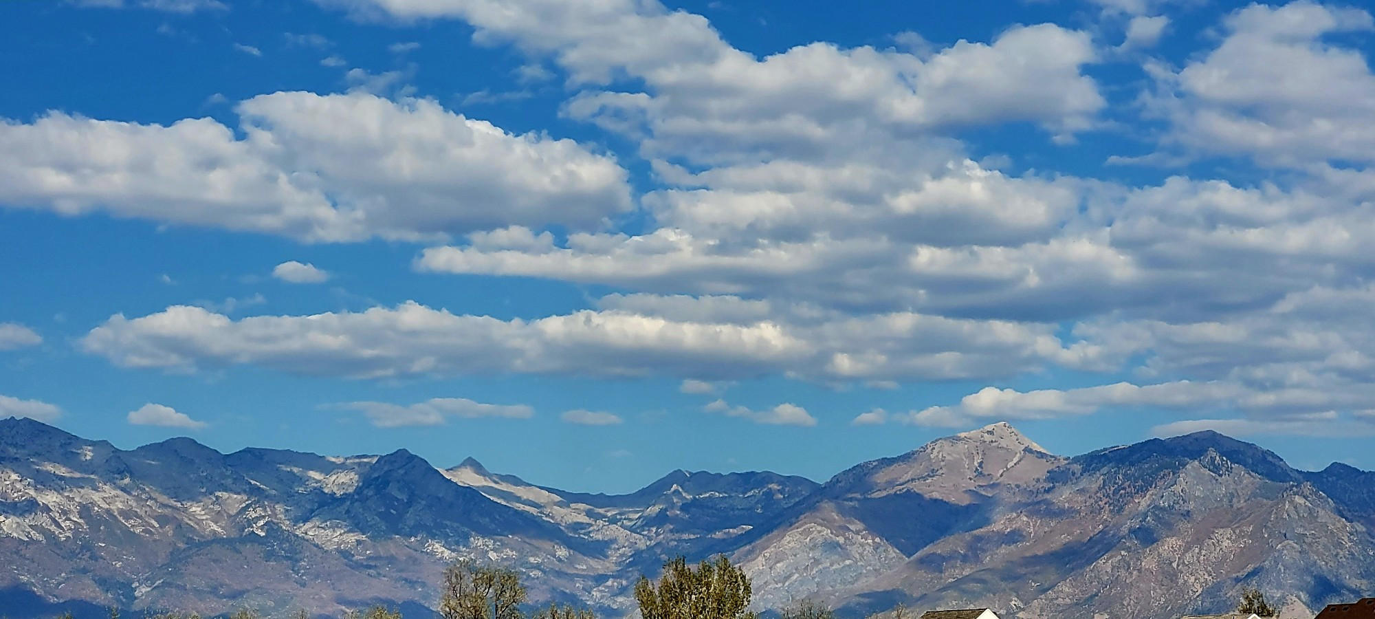 Mountains with blue sky and fluffy cloud formation ©AVM 2024 Utah Lake