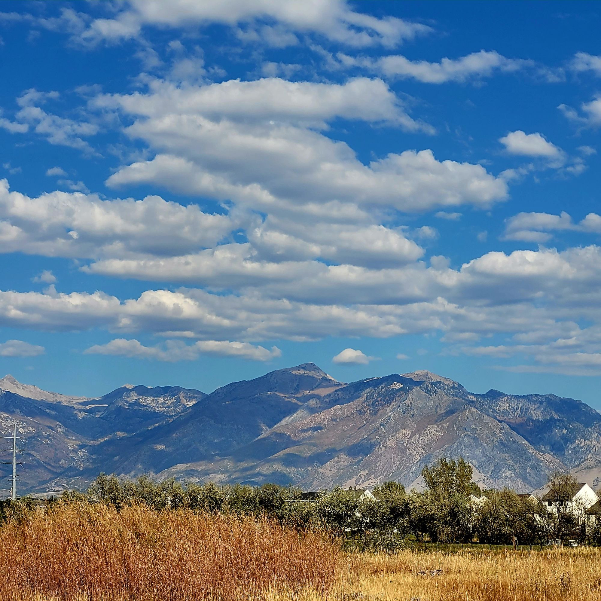 Mountain range, cloudy blue sky ©AVM 2024 Utah Lake