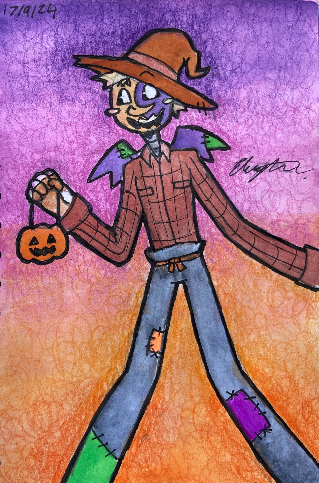 Jack dressed as a scarecrow with a flannel top and a scarecrow hat. With patch work trousers to match! He holds a little pumpkin bucket in his right hand and is all excited for trick or treating