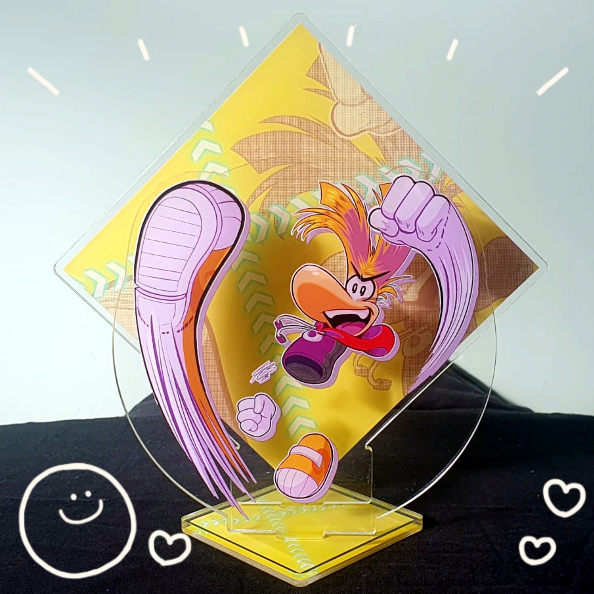 Photo of my Rayman acrylic standee where he's punching, kicking and has a big open smile.