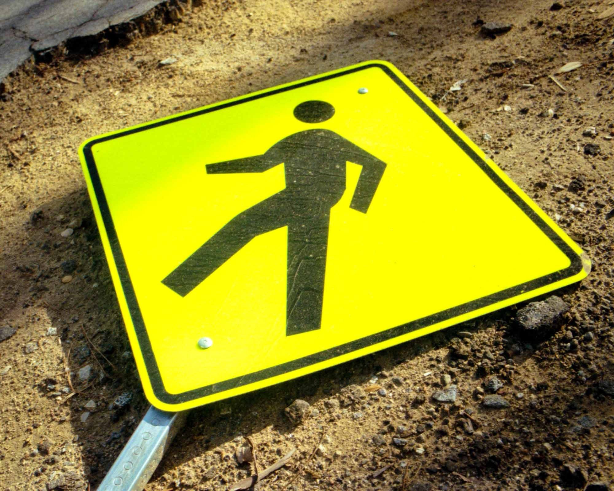 A bright yellow fallen cross-waking sign. Los Angeles, California – shot on film