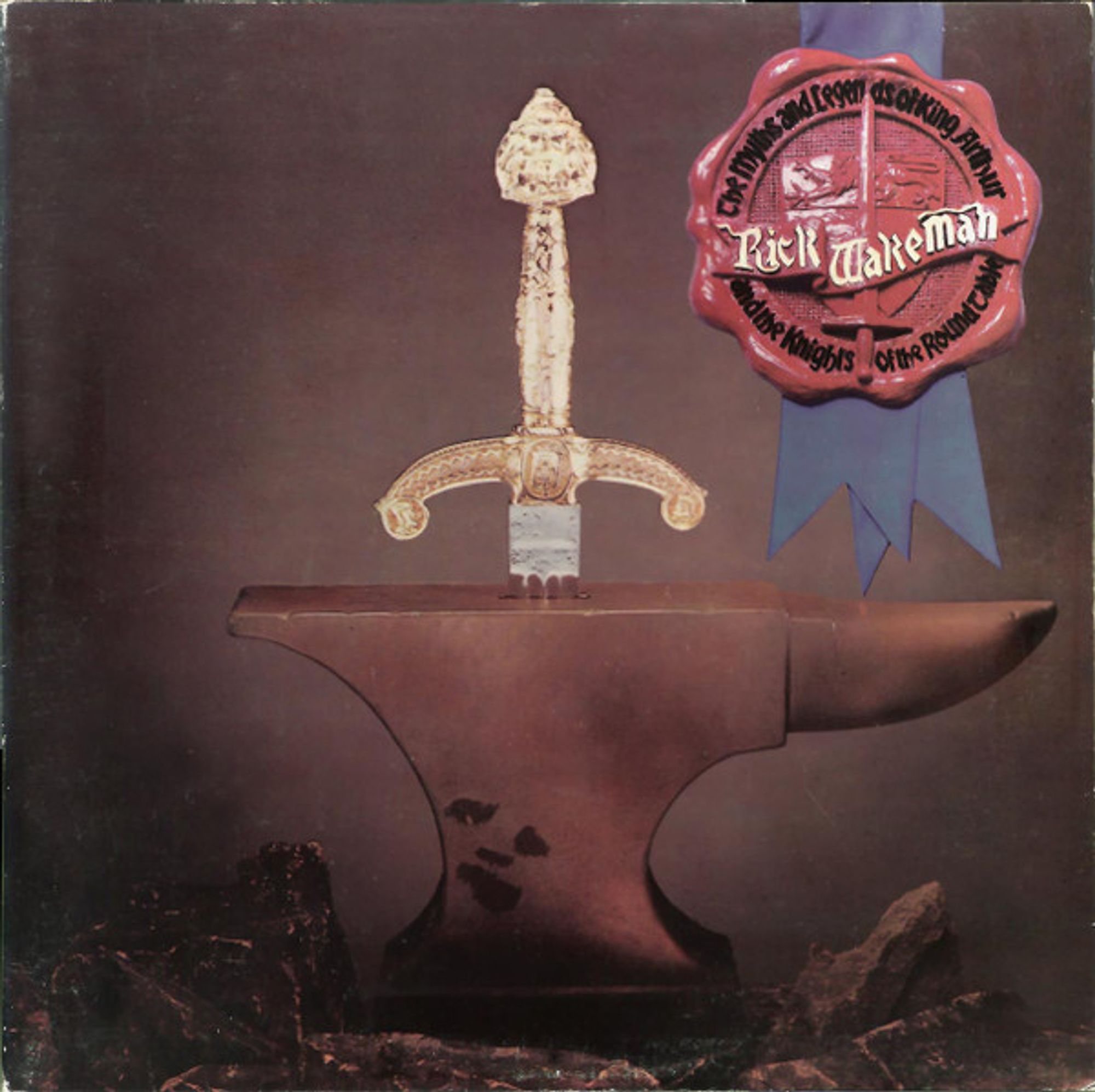 The cover of Rick Wakeman's King Arthur album. A photo of a sword hilt coming out of an anvil. The photo has been adorned with blue ribbons affixed with Wakeman's very own personal wax seal of approval