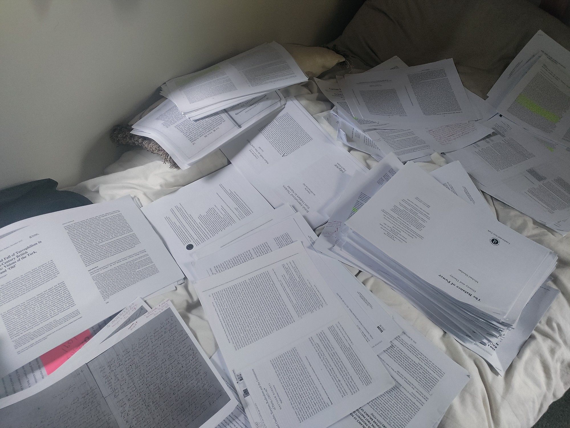 A year and a half of papers strewn across a bed.