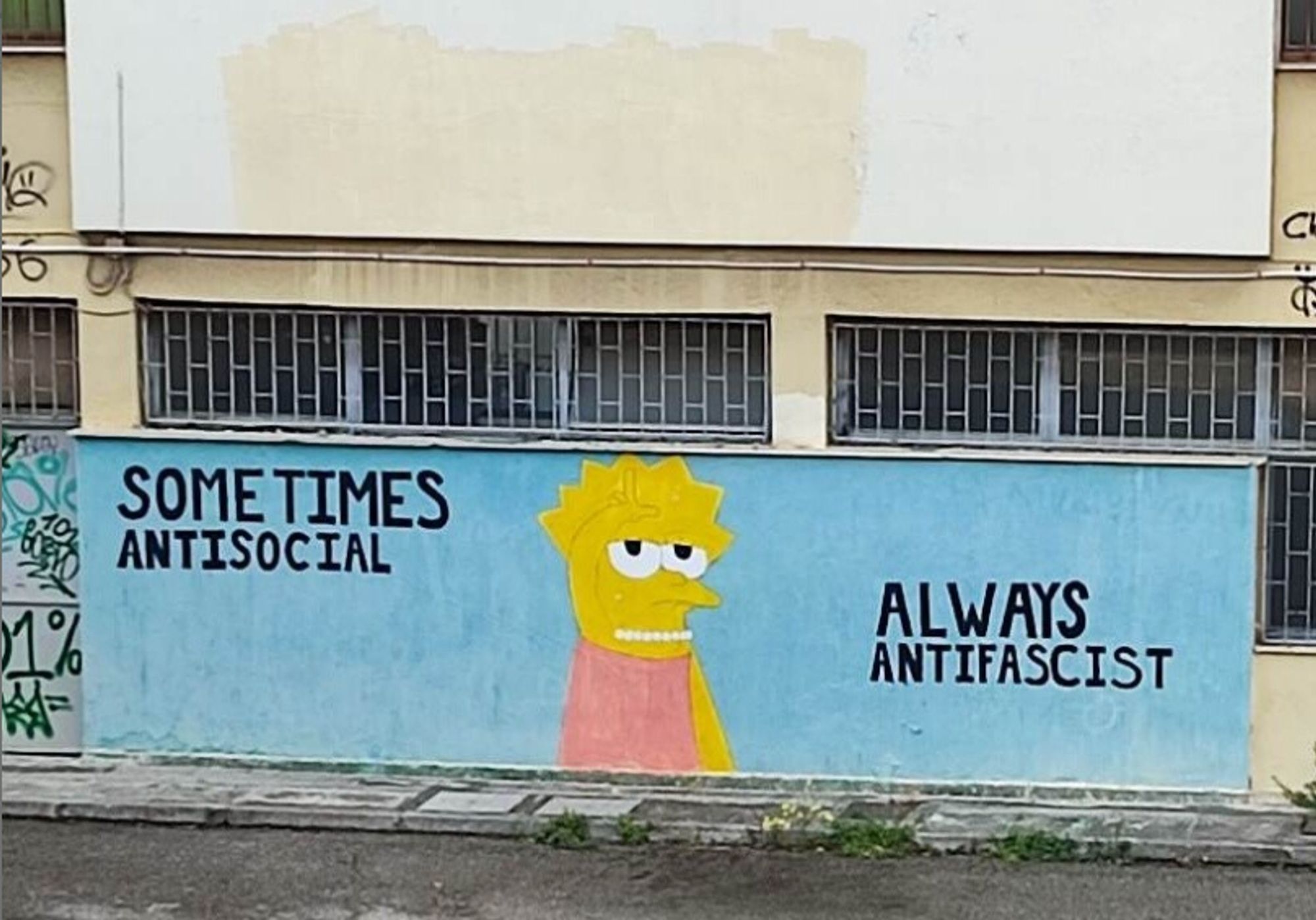 Lisa Simpson wall art with the text "sometimes antisocial, always antifascist." She holds her hand in the shape of an L on her forehead.