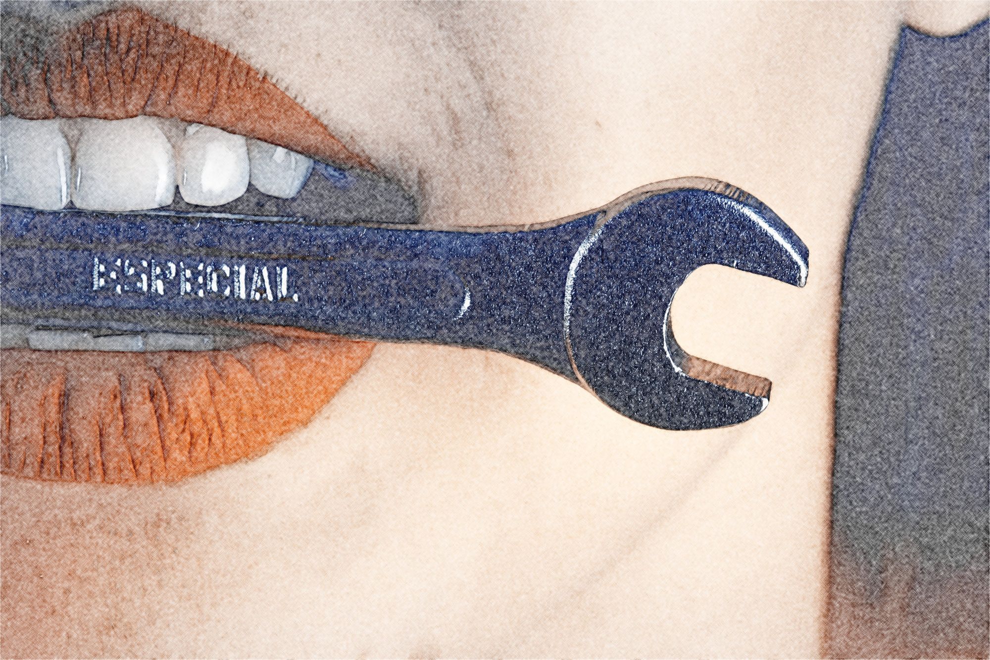 A girl holding a spanner between her teeth.