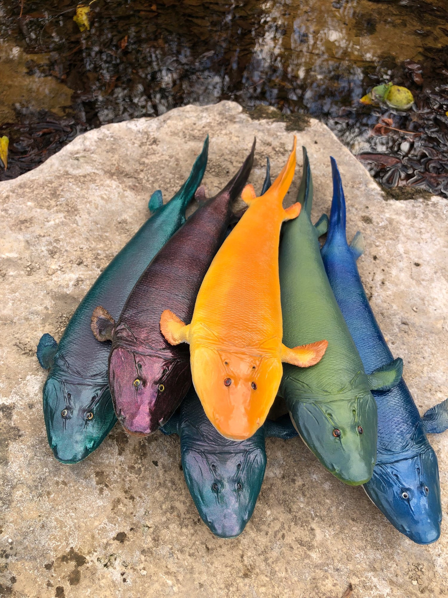 Group of colorful Tiktaalik models.