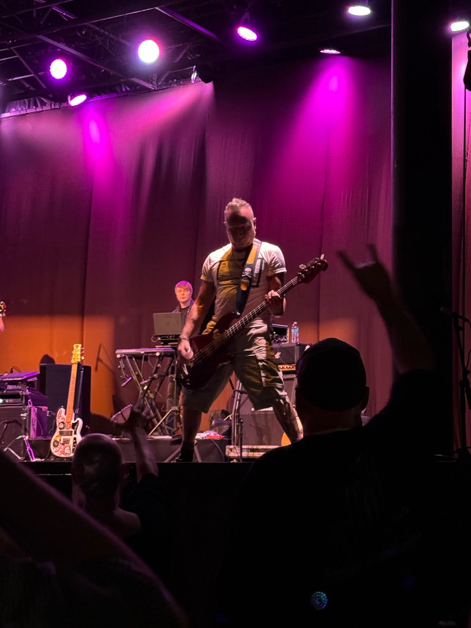 Peter Hook playing bass on stage