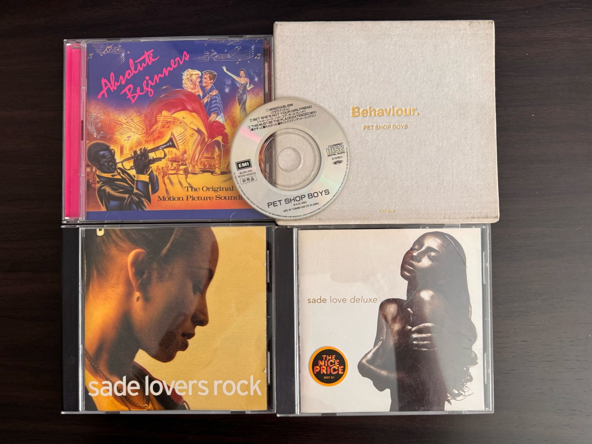 CDs arranged 2x2 with a 3” CD on top. 
Sade Lover Rock
Sade Love Deluxe
Pet Shop Boys Behaviour Japanese white velvet box w/ 3” bonus CD