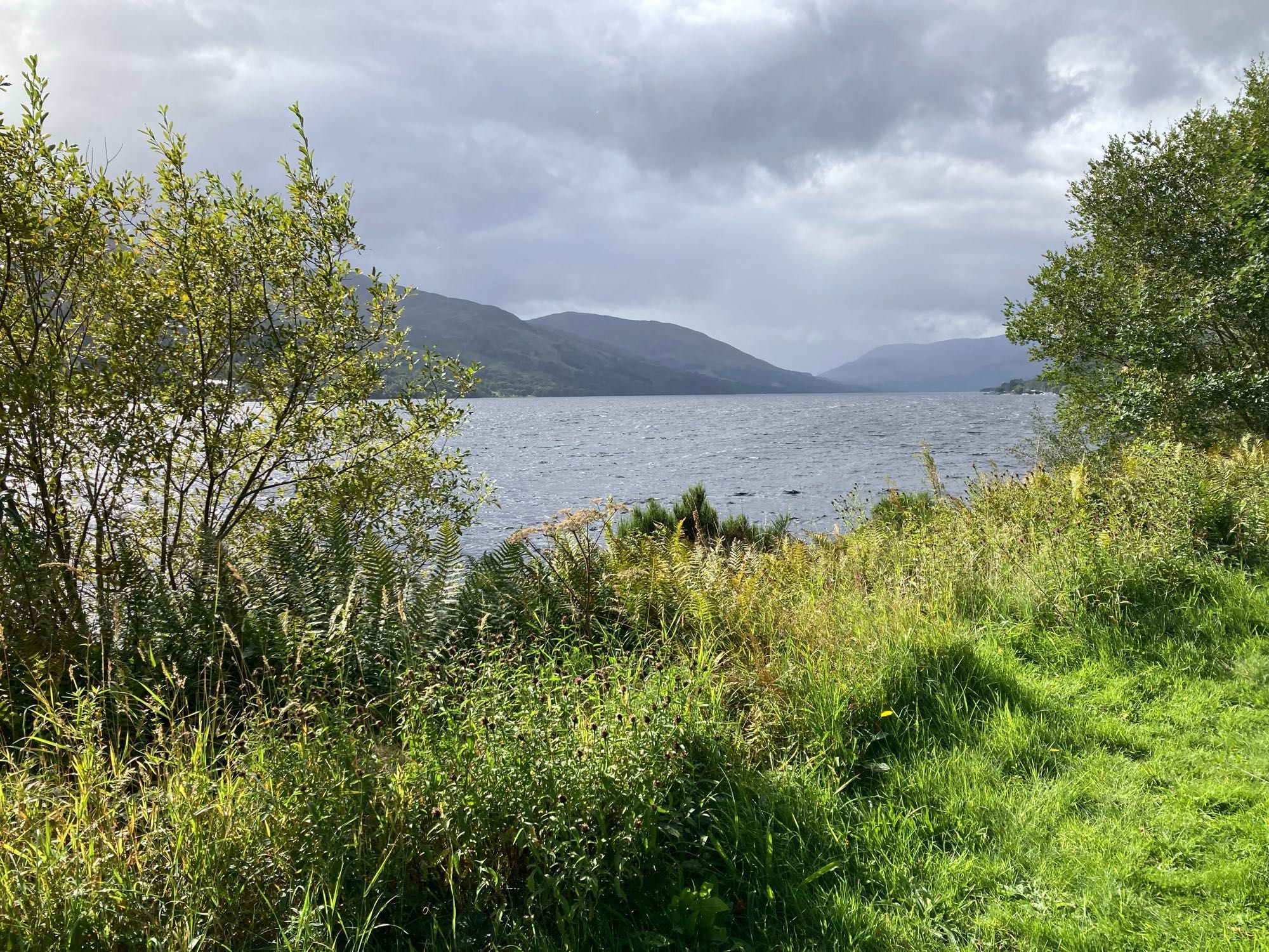 Looking down loch to hills in the distance. Low cloud and rain on its way.