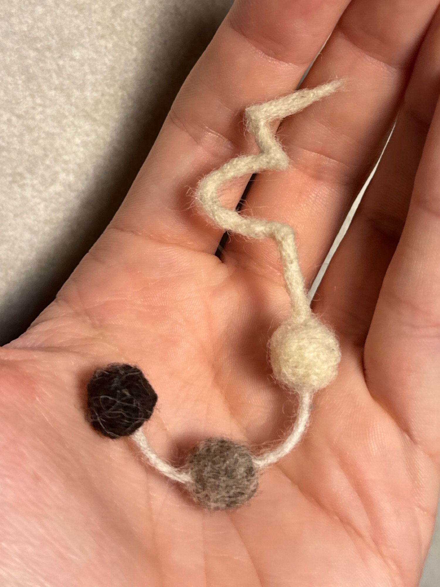 The same felted object as described in the other picture but this time curled up in my hand.