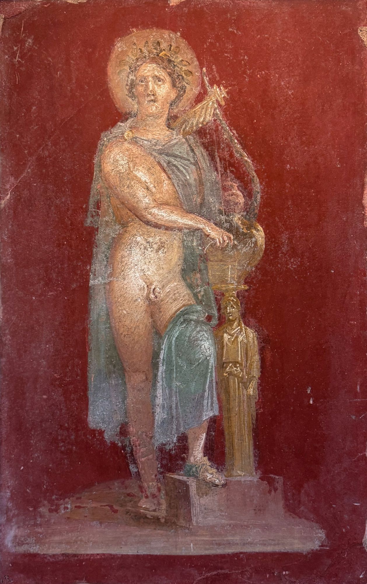 This fresco from the Casa dei Dioscuri (or the House of Castor and Pollux) in Pompeii depicts Apollo strumming his kithara, a stringed instrument similar to the lyre. He’s heroically nude, save for his green chlamys (cloak). The kithara rests on a golden caryatid wearing a Greek peplos, perhaps representing one of the muses, as this type of Apollo is also known as Apollo Musagetes, or ‘Apollo, Leader of the Muses’. 

From Pompeii (Casa dei Dioscuri)
1st century CE, before 79 CE

British Museum (1857,0415.1)