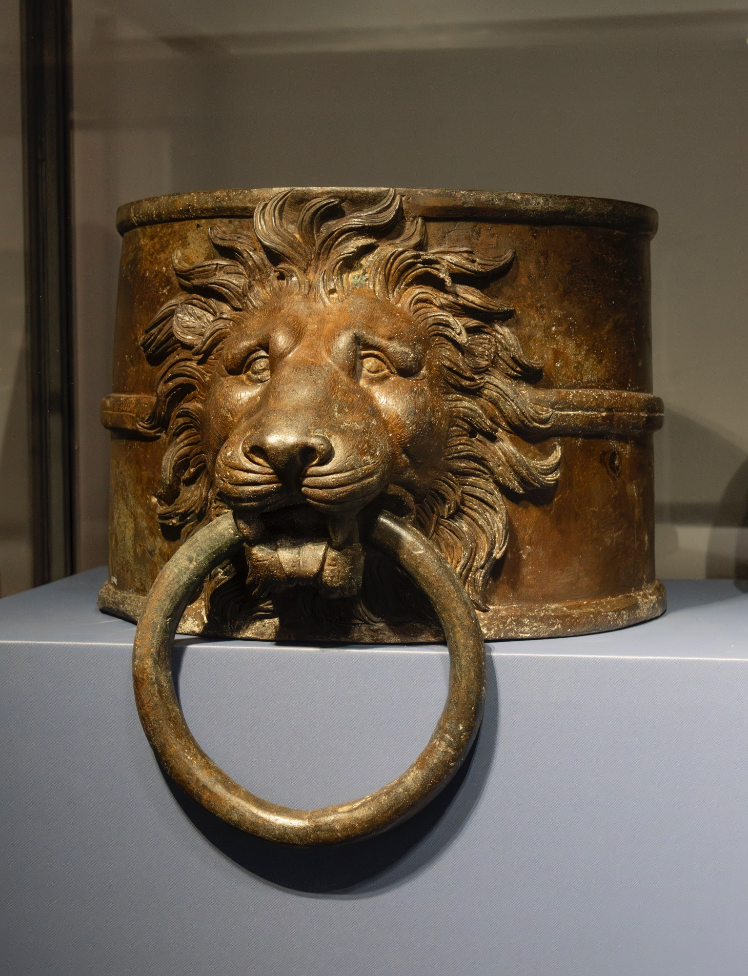 A magnificent set of cast-bronze fittings (the heads of four wolves, three lions, and one panther) were salvaged in 1895 from the remains of Caligula's so-called pleasure barge, the 'prima nave', the first of two ships to be excavated from Lake Nemi. This is one of the cylindrical lion head caps which crowned the long shafts of the side-rudders. There's some debate about whether the rings were used to secure the ship to the dock, or whether they were ornamental or used for hanging garlands.

As to the remainder of the bronze animal protomes on the prima nave, the big cats (lions and a panther) adorned the main crosswise structures of the ship, the wolves the lengthwise structures. The lions have a tamer appearance whilst the wolves are fiercer: their bared teeth, taut muscles and small lowered ears give these animals a proud beauty, exalted by the use of bronze. Standing out in this group is the panther, whose spotted coat is rendered by damascening, a special artistic metal-working technique used to obtain a multicoloured decoration; in this case sheets of copper and tin have been inserted onto the metal surface. 

Age of Caligula (37 - 41 CE). Bronze, lost-wax casting, finished by hand with burin and chisel

Museo Nazionale Romano, Palazzo Massimo alle Terme, Rome