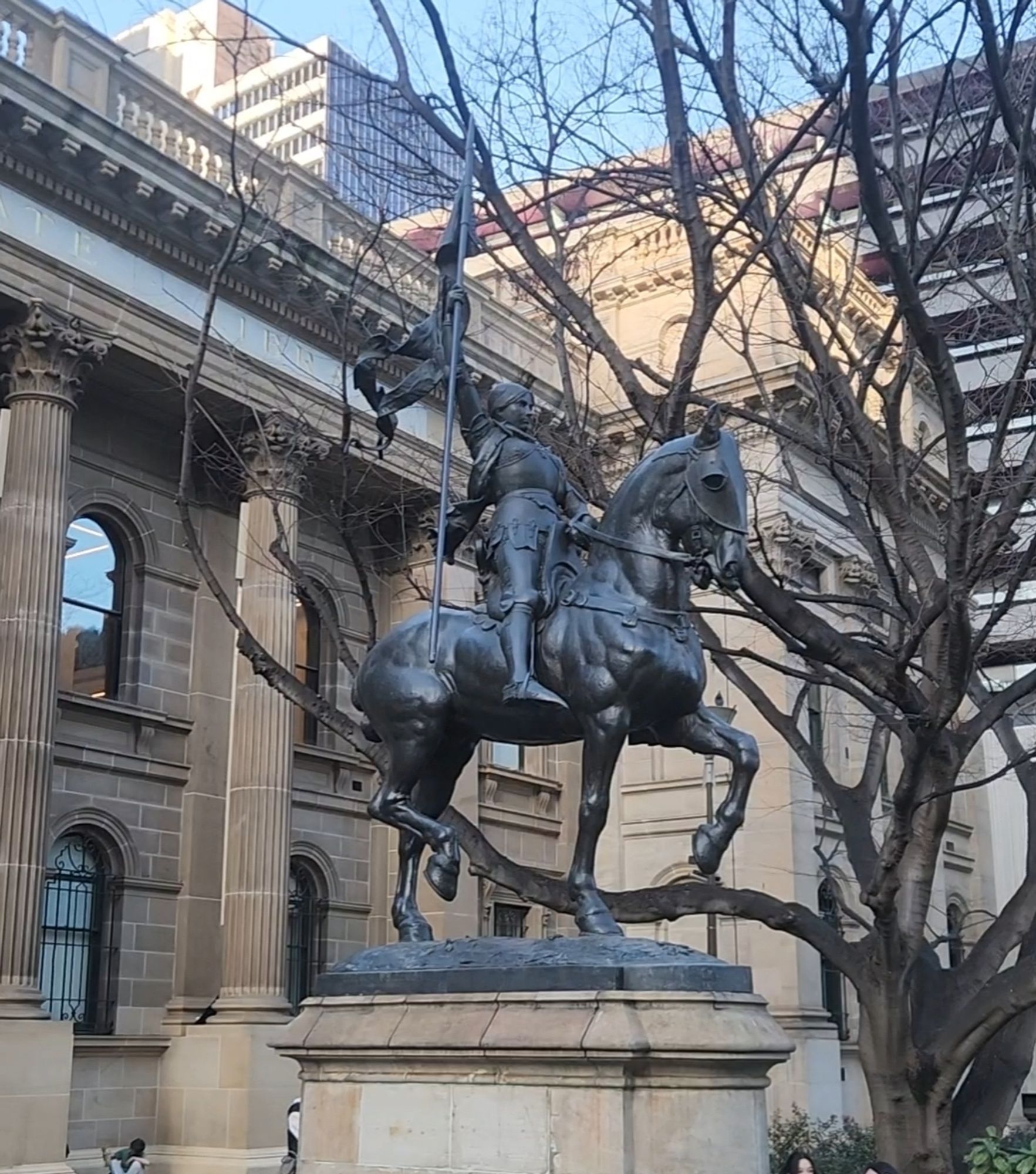 Joan of Arc statue outside the State Library of Victoria holding the flag that's been missing for 6 months