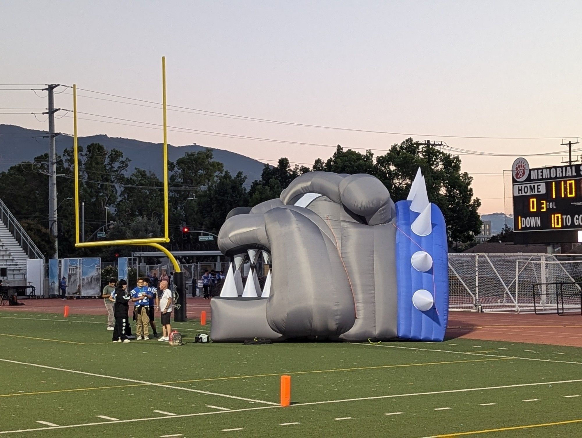 A giant inflatable bulldog head on a football field