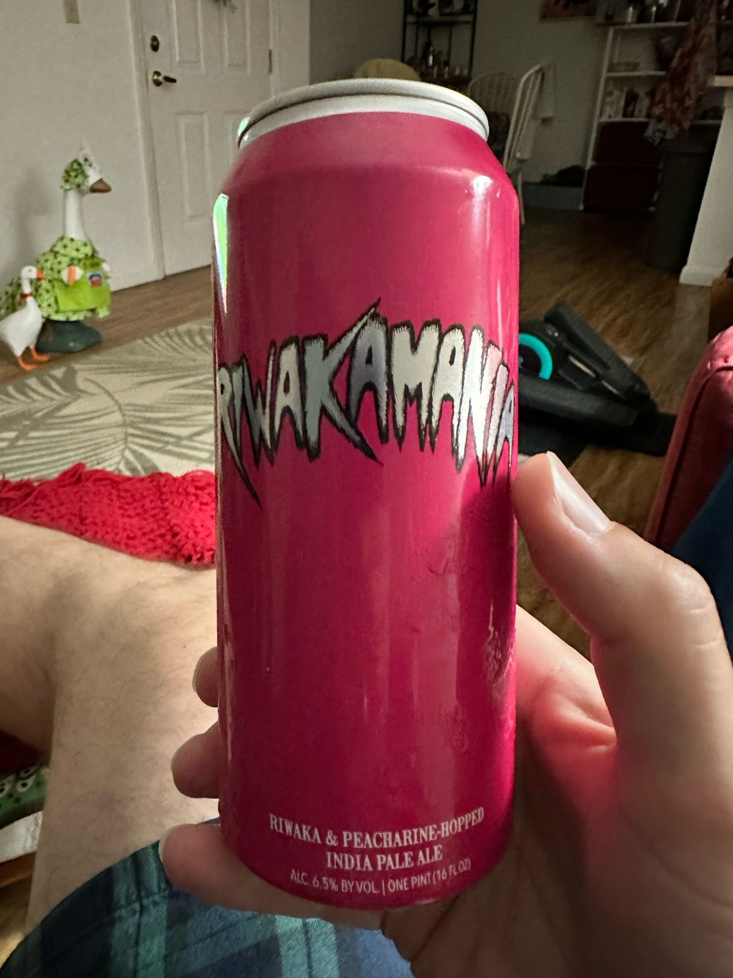 Riwakamania, a beer from Hop Butcher For The World, written in a silver Hulkamania font on a Barbie pink background. This is a hazy IPA with Riwaka and Peacharine hops. 